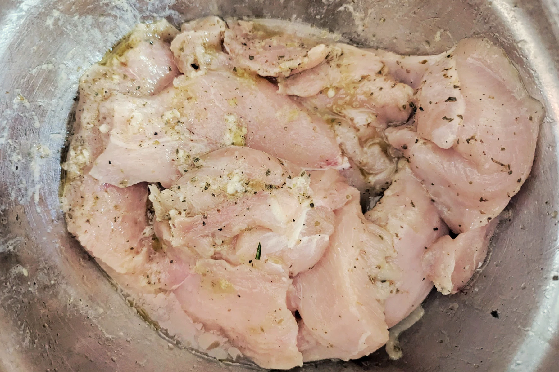 Marinated chicken in a bowl.
