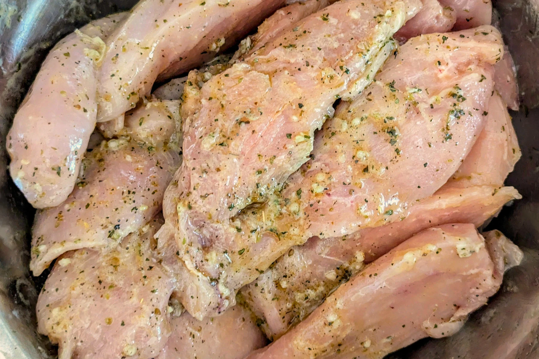 Marinated chicken in a bowl.